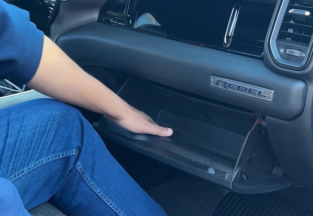 Empty glove box of a Dodge Ram Rebel trucl, demonstrating Step 1 of the Dust Armor CAFDA-R01 cabin air filter replacement process.